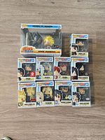 Front view of all ten boxed figures stacked