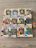 Front view of 12 boxed standard Pops and 1 Pocket Pop keychain