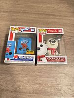 Front view of both boxed Funko Pop figures