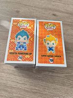 Front view of both Funko Pop boxes showing characters and numbers