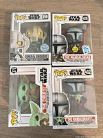 Front view of four Funko Pop! boxes showing characters and stickers