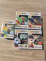 Front view of all five boxed figures in protectors