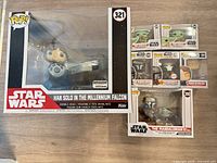 Group shot showing all seven boxed Funko Pop! figures, including Han Solo deluxe and six additional figures