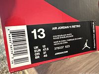 Size label on original shoe box showing Air Jordan 11 Retro, Gym Red/Black-White, US 13, other size conversions