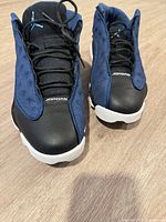 Front top view of both shoes showing toe leather, mesh panels, laces, Jumpman logo