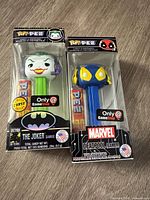 Front view of both boxed Pop! PEZ dispensers showing characters and GameStop exclusive labels