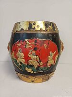 Front view showing red cartouche with gilt figures and wear at rim and base