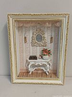 Front view of framed diorama showing entire Victorian scene within white and gold frame