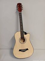 Front view of Grit 6-string acoustic guitar showing body, fingerboard and bridge