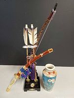 front view of entire lot showing weapon display and vase