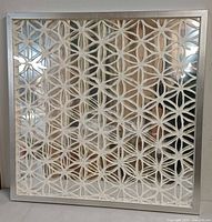 Full frontal view of square framed paper art