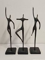 Front view of three bronze ballet dancer sculptures