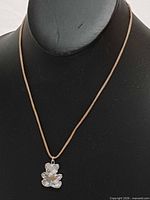 Full view of necklace on display bust showing pendant and cord