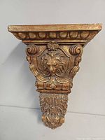 Front view showing lion head relief and overall ornamentation