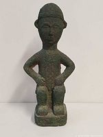 Front view of pottery figure showing overall form and surface texture