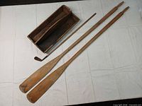 Overview of lot: two paddles, golf iron, wooden toolbox
