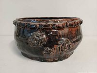 Front view showing floral relief and glaze finish