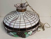 Full view of stained glass hanging lamp showing grid pattern and chain