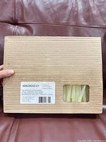 Closed cardboard box showing partial view of glue sticks