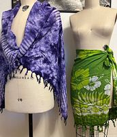 Both sarongs displayed on dress forms, showing overall appearance