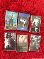 Front view of all six cassette albums