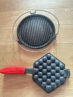 Top view of both cast iron pieces on wooden floor