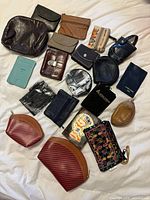 All 20 wallets, purses and pouches laid out