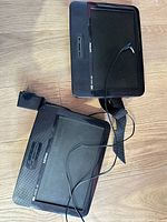 Front view showing both Philips portable DVD players with screens and front speakers