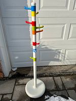 Full view of IKEA Krokig coat stand showing colourful hooks and white weighted base