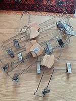 All seven IKEA wood and wire pant hangers stacked