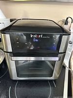 Front view of Instant Vortex Plus air fryer oven powered on