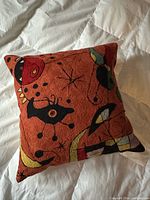 Front view of embroidered Miró design cushion