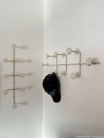 Both wall racks shown for context; left unit demonstrates design, right unit shows scale with hat