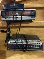 All three clock radios stacked on wooden steps