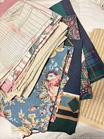 Stack of assorted vintage pillowcases displayed on bed