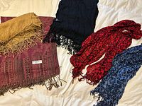Group of five scarves arranged on surface