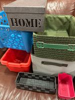 All seven storage containers stacked on couch