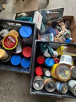 Top view of two milk crates and cardboard box filled with hardware containers