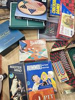 Assortment of boxed games including Chinese Checkers, Checkers, Yahtzee, Master Mind, Rummoli, Pit, Cribbage board visible