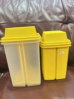 Both Tupperware pickle containers showing size difference and overall condition