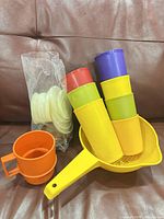 Full lot showing colander, tumblers, mug and bag of lids
