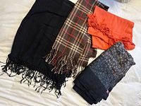 Overall view of four scarves laid out