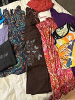 All garments laid out on bed full view