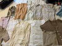 All ten garments laid flat showing full lot