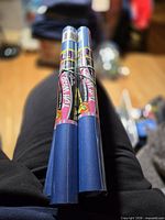 Two of the blue book cover rolls standing vertically showing front labels