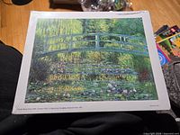 Front view of shrink-wrapped Monet print showing artwork and sealed edges
