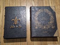 Front covers of both faux book boxes showing gold designs and titles