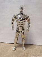 Front view of chrome Silver Surfer action figure standing upright