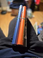 Front view of four bundled adhesive book cover rolls showing blue and orange colours