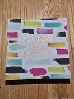 Front of canvas showing brush-stroke pattern and gold text